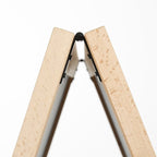 View from above of the hinge holding the two timber legs of a blackboard A-frame together