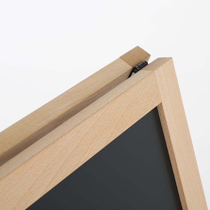 Detail of the hinge and timber top rail joining the two panels of a wooden blackboard A-frame