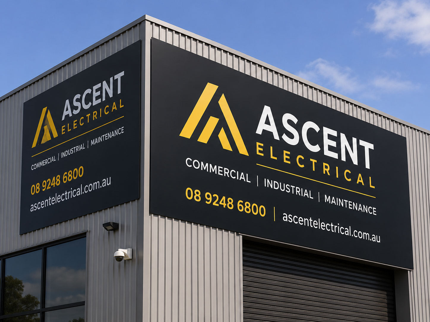 Large aluminium composite panel sign for an electrical contractor mounted on the corrugated wall of an industrial unit