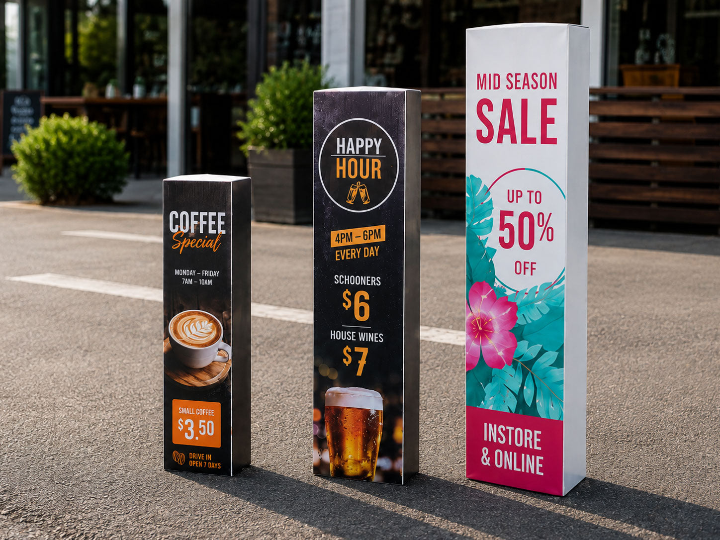 Three printed bollard signs in a car park advertising a coffee special, happy hour and a mid season sale