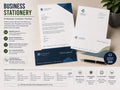Business stationery set with printed letterheads, compliment slips and envelopes arranged on a desk beside a pen