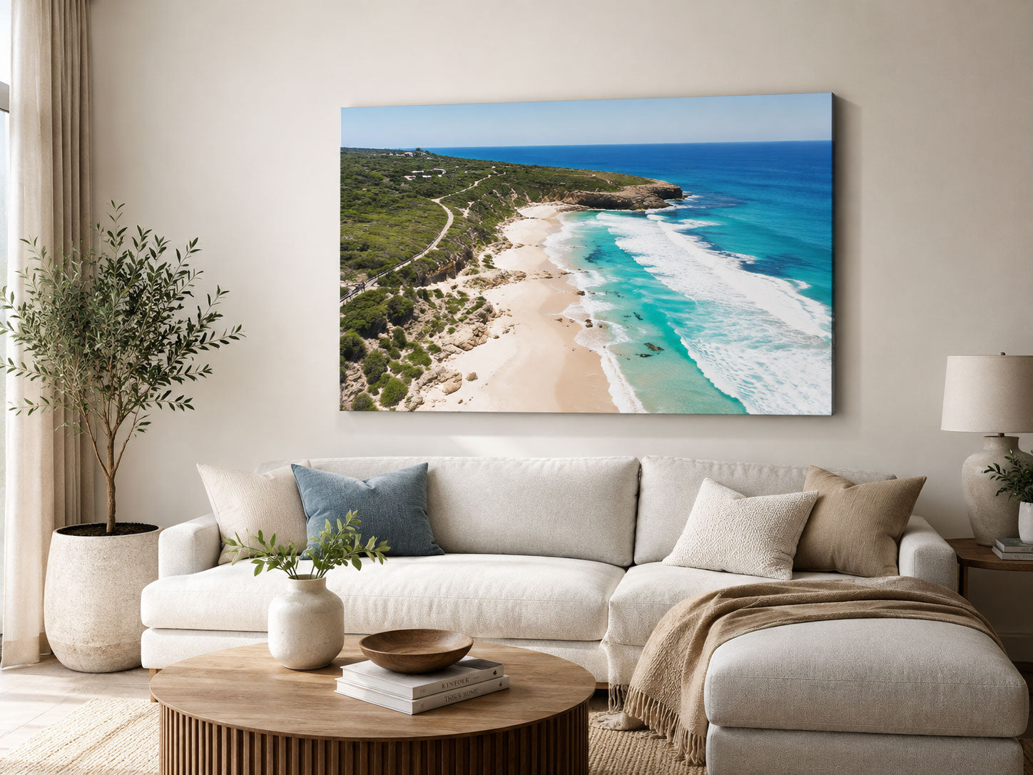Canvas print of an aerial coastal scene hanging above a sofa in a living room