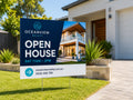 Real estate open house corflute sign on wire stakes in the front lawn of a modern house