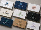Ten business cards in navy, kraft, black and white laid out in rows, each with a different small-business logo