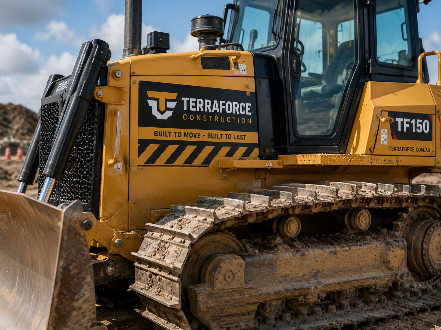 Construction company logo applied in vinyl to the side of a bulldozer on a work site