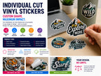 Die cut vinyl stickers with outdoor and adventure designs on a laptop, drink bottle and a hand peeling one off