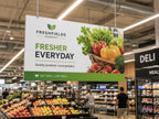 Printed Kappa display board hanging from the ceiling of a supermarket above the fresh produce aisle