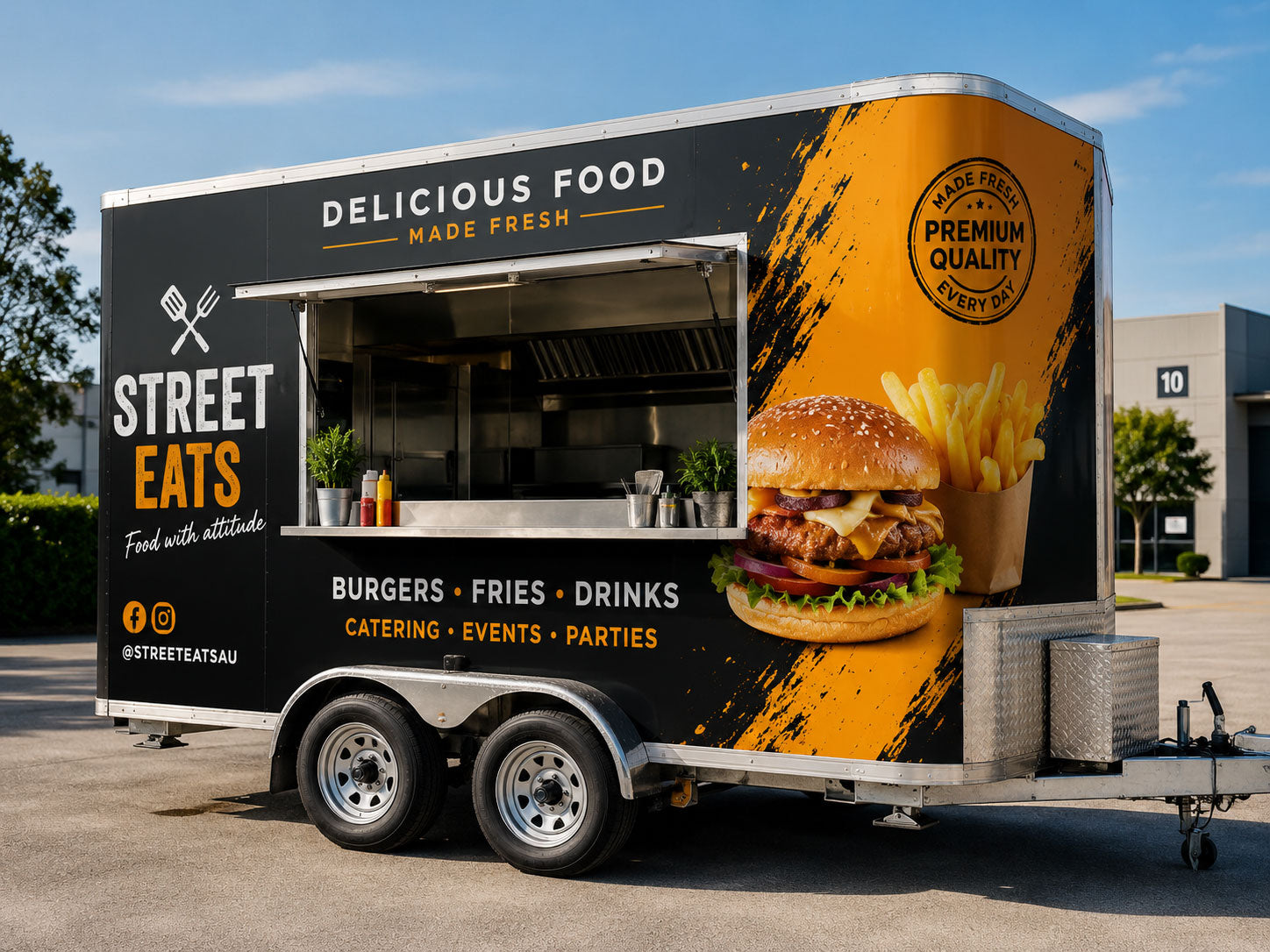 Food trailer fully wrapped in printed vinyl with burger artwork, parked outside an industrial unit