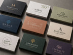 Nine premium business cards in navy, olive, terracotta and cream, each with a different small-business logo