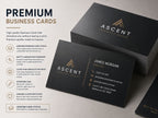 Premium black business cards with gold foil detailing, stacked and fanned on a pale surface