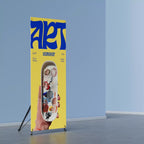X frame banner stand displaying an art workshop print in a room with blue walls
