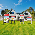 Row of Ready To Go auction signs on a front lawn