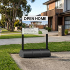 Open home sign on a water-fill base outside a house